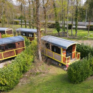 Hébergement insolite : roulottes colorées entourées de verdure à Champagne-Ardennes.