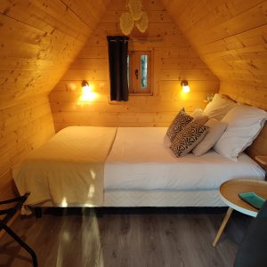 Cabane en bois cosy en Bourgogne, avec lit douillet et décoration chaleureuse.