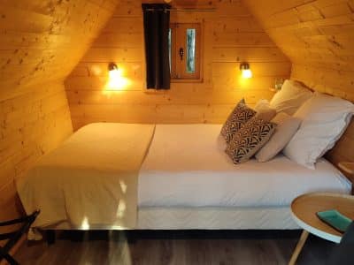 Cabane en bois cosy en Bourgogne, avec lit douillet et décoration chaleureuse.