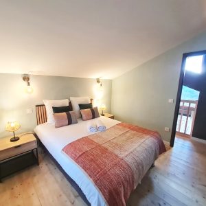 Chambre cosy dans un hébergement insolite, avec lumière douce et décoration moderne.