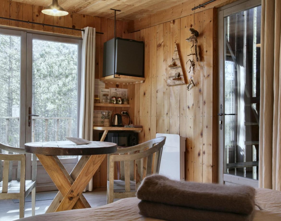 Cabane en bois dans les Alpes, avec un intérieur chaleureux et lumineux.