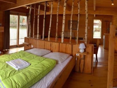 Chalet en bois chaleureux avec lits superposés et vue sur la nature environnante.