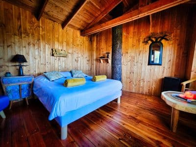 Chalet en bois chaleureux avec lit douillet et décor naturel au Limousin.