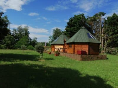 Cabane en bois avec toit conique, entourée de verdure à Midi-Pyrénées.