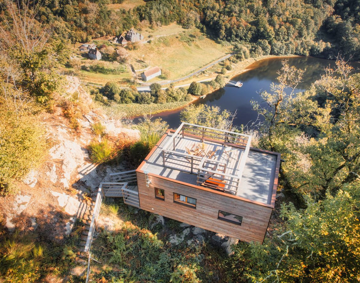 Cabane perchée à Limousin avec terrasse panoramique sur le lac et la nature environnante.