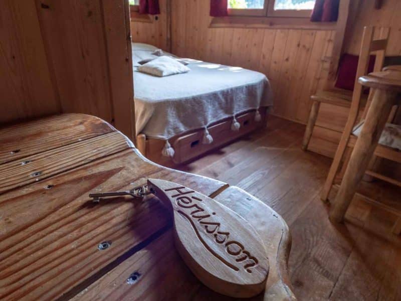Chalet en bois chaleureux avec lit douillet et vue sur la nature.
