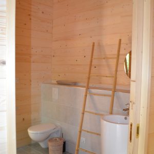 Salle de bain moderne en bois dans un hébergement insolite en Nouvelle-Aquitaine.