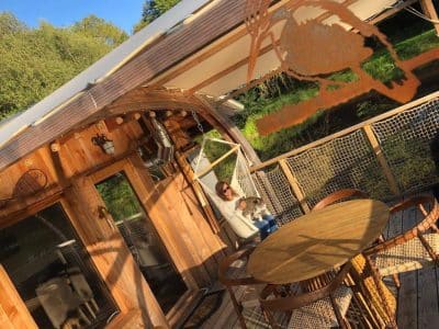 Hébergement insolite en roulotte à Limousin, avec terrasse en bois et vue sur la nature.