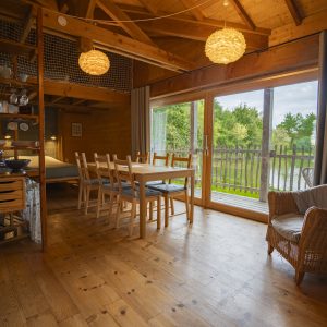 Cabane en bois avec vue sur la nature, lumineuse et chaleureuse, idéale pour un séjour.