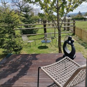 Hébergement insolite en Pays de la Loire avec terrasse en bois et chaises modernes.
