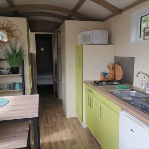 Hébergement insolite en Pays de la Loire : cuisine moderne avec meubles verts éclatants.