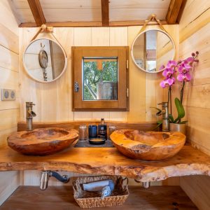 Salle de bain en bois avec vasques en bois, hébergement insolite en Aquitaine.