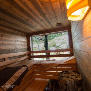 Sauna en bois chaleureux avec vue sur la nature, idéal pour un séjour relaxant.