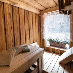 Sauna en bois chaleureux avec bancs en bois et fenêtre lumineuse à Grand-Est.