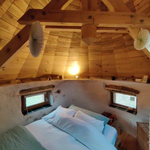 Chalet en bois rond avec un intérieur chaleureux et lumineux, idéal pour un séjour cocooning.