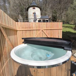 Hébergement insolite en Midi-Pyrénées : un gîte en pierre avec jacuzzi en bois.