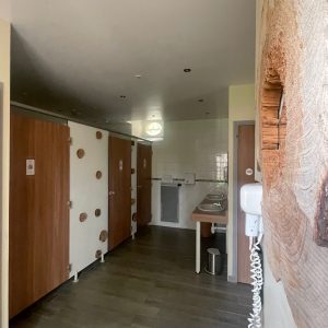 Salle de bain moderne avec cabines en bois, offrant un hébergement insolite et chaleureux.