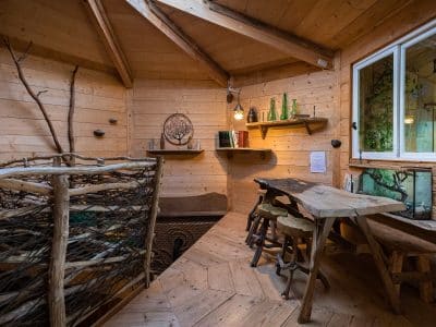 Cabane en bois chaleureuse avec un intérieur en bois clair et une table rustique.