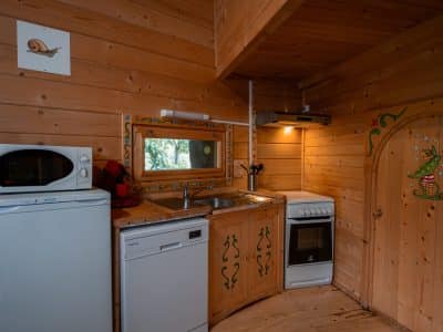 Cabane en bois en Nouvelle-Aquitaine avec cuisine équipée et décor coloré.