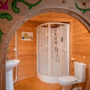 Cabane en bois en Nouvelle-Aquitaine avec salle de bain moderne et décor coloré.