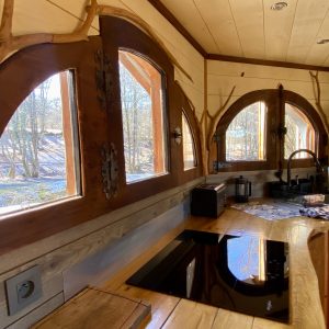 Cabane en bois avec fenêtres en arc et décor en bois naturel à Midi-Pyrénées.