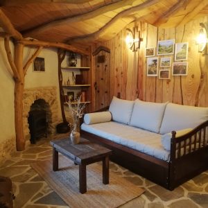 Cocon en bois en Nouvelle-Aquitaine, intérieur chaleureux avec pierres et lumière douce.