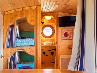 Hébergement insolite en Auvergne-Rhône-Alpes, intérieur en bois avec lits superposés.